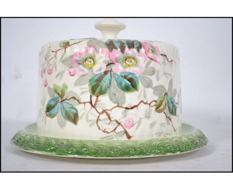 A 19th century Victorian ceramic circular cheese dish and base with hand painted  flower and butterfly design. Measures 17cm 
