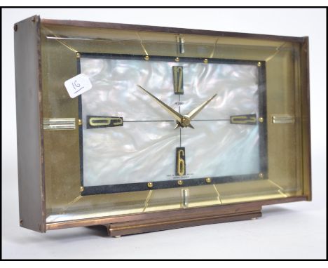 A vintage 20th century Metamec mother of pearl automatic clock of rectagonal form having mother of pearl face with gold borde