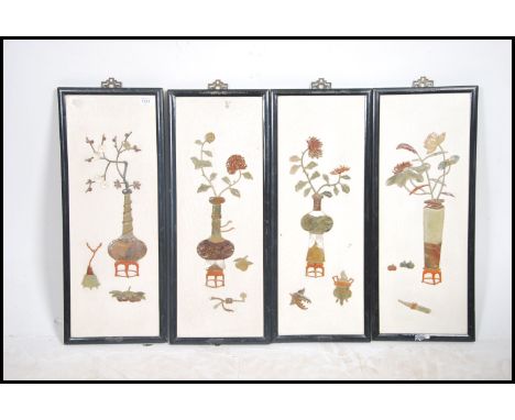 A group of four Chinese ceramic and marble framed plique a jour wall plaques each inlaid with a different scene please see im