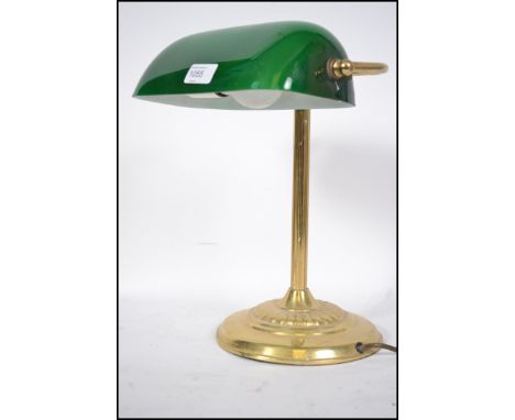 A 20th century contemporary green glass and brass bankers desk lamp having glass rectangular shade that adjusts
