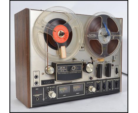 An original vintage Akai 4000DS model reel to reel tape recorder player set within original wooden surround with decorative f