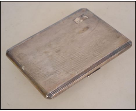 A silver hallmarked engine turned cigarette case bearing Birmingham assay mark, makers mark for E J Trevitt & Sons and dating