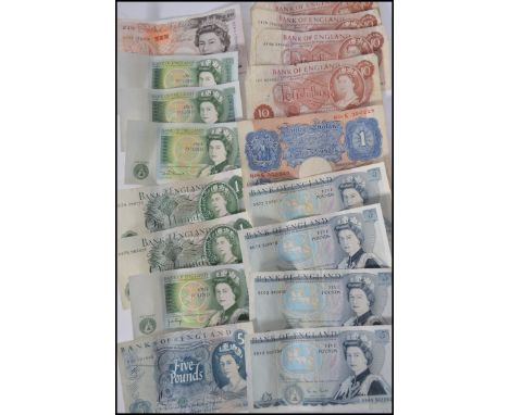 A collection of vintage bank notes to include a blue one pound Peppiatt note, pound notes, ten shilling notes, Five pound not