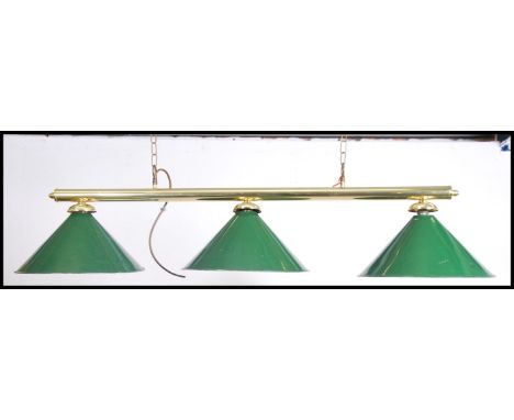 A modern brass ceiling mounted, hanging snooker table down light. Three lights and 3 baize green glass shades of conical form