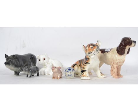 A collection of Beswick ceramic figurines to include grey pig sow and piglet, spaniel dog together with other figurines