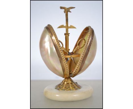 A 19th century continental mother of pearl and gilt metal sewing case, the alabaster circular base supporting a gilt tooled s