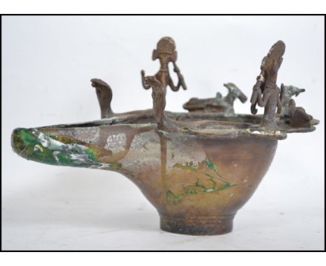 An unusual anglo colonial cast metal 19th century oil lamp - burner surmounted with deities possibly from India.