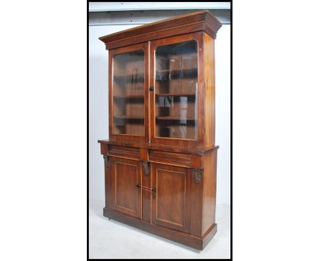 A Victorian mahogany library bookcase cabinet. Raised on plinth base with white ceramic castors supporting a double door cupb