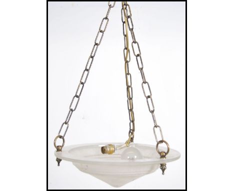 A contemporary 20th century ceiling light having three brass chain links with a circular convex mottled glass shade.