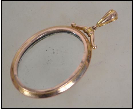 A vintage 9ct gold window locket. Oval form with bale atop and twin windows. Total weight 3.2g exc windows