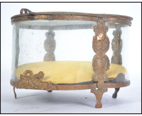 A large 20th century bevelled glass and gilt metal ormulu casket raised on shaped legs with a lined cushion interior to the u