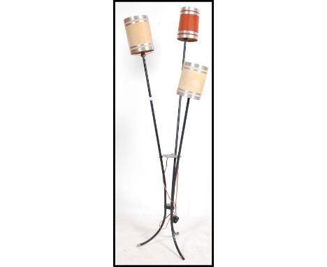 A 20th century French retro floor standing three point lamp, constructed from tubular metal raised on splayed legs.