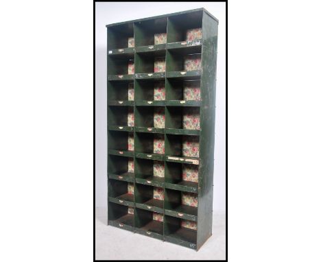 A vintage mid century Industrial sectional metal factory pigeon holes/cubby cabinet unit with notation slides, consisting of 