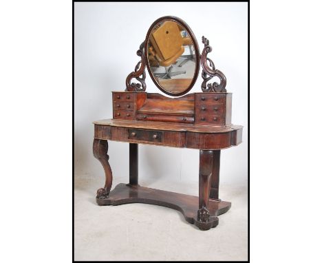 A Victorian mahogany duchess dressing table raised on turned supports with serpentine shaped dressing table having trinket dr