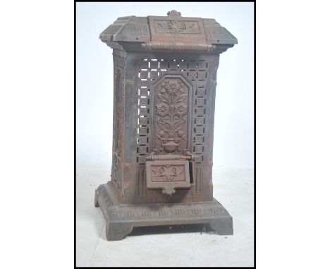 A large early 20th century decorative cast iron architectural stove - wood / coal burning. The large stove of stunning lattic