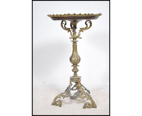 A 19th century French continental Empire mahogany and gilt metal tripod wine table The pierced brass galleried top above a br