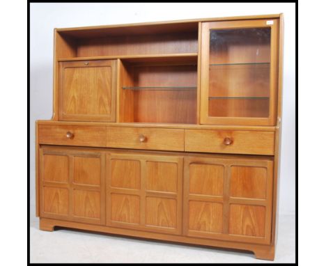 A vintage 1970's Nathan Furniture teak sideboard having quarter panel cupboards over short drawers having a raised cabinet ba