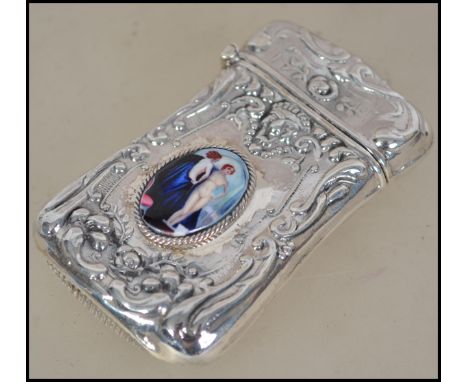 A silver vesta case having an embossed design with inset nude erotic pictorial enamel to centre. Weight 32g. Measures 5cm lon