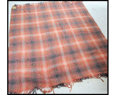 A Northern Irish vintage mid century Abercorn rug having chequered red and black design with original label. Measures 190cm h