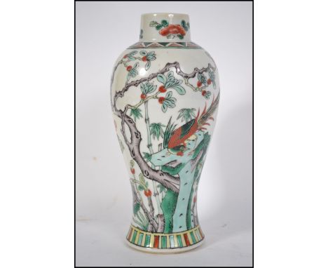 A Chinese vase believed 19th century being decorated with scenes peony tree's and asiatic pheasants. Geometric patterns to th