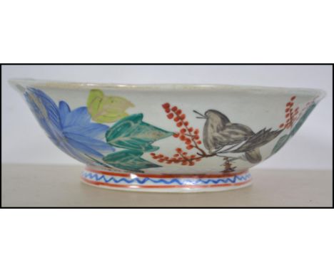 A believed 19th century Chinese ceramic famille rose bowl with handpainted decoration being signed to the base