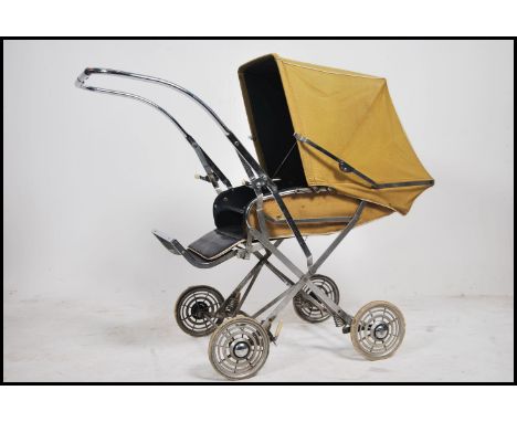 A vintage / retro 20th century Comfifolda child's pushchair, with covers and operational hood. Measures 92cm high x 49cm wide