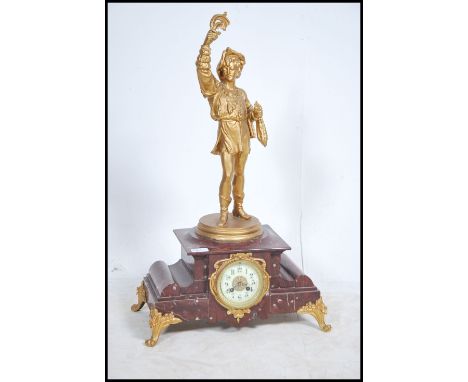 A 19th century large French rouge marble mantel clock. The large rouge marble base raised on gilded enamel supports having a 