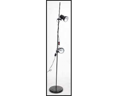 A retro 20th century 1980's black floor standing twin spot / spotlight lamp. Having adjustable twin spots raised on a metal t