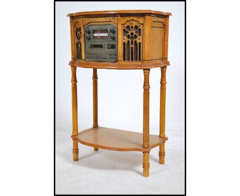 A contemporary vintage style oak cased record player / hi-fi system. Encased within an oak effect cabinet raised on reeded le