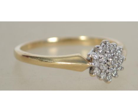 A ladies vintage 9ct gold cluster diamond ring having flower head design. Total weight 2g / Size O.5