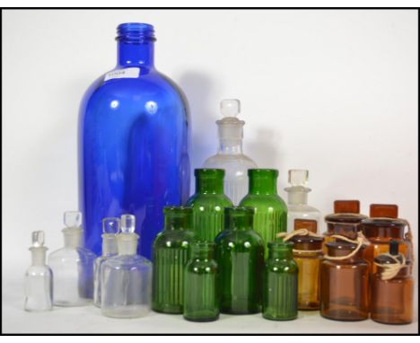 A collection of vintage blue and green glass Apothecary bottles dating back to the early 20th century