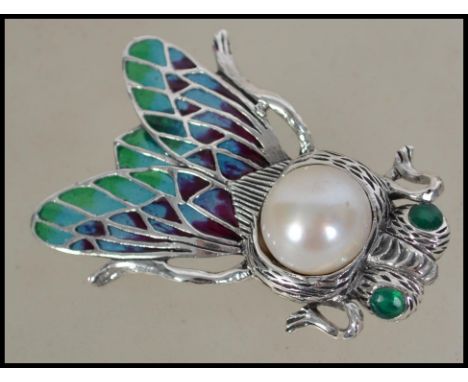 A silver plique a jour bug brooch in the form of a fly with large central freshwater pearl to centre having pin verso. 4cms l