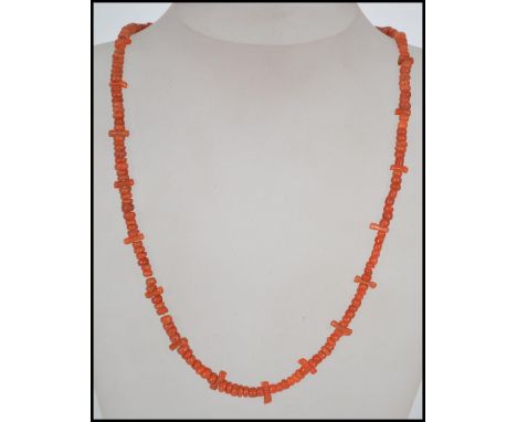 A vintage red branch coral necklace with yellow metal clasp together with another coral necklace 