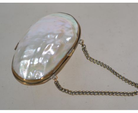 A late 19th century mother of pearl penny purse. The hinged body having a gilt mount, chain handle opening to reveal a lined 
