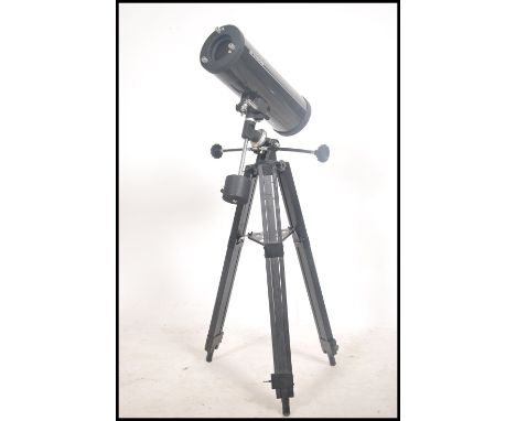 A contemporary Tasco telescope complete with the tripod stand ( see illustrations ) 
