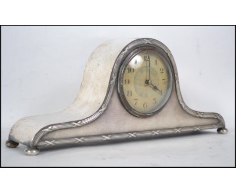 A silver plated Napoleon mantle clock the  enamel dial with Arabic numerals and a French made movement 