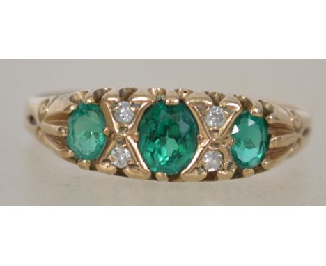 A vintage 9ct gold diamond and emerald ladies. The 3 oval cut emeralds interspersed with diamonds. Weight 2.0g