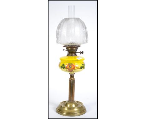 A Victorian oil lamp having a stunning acid etched glass shade set over a yellow glass handpainted reservoir and brass neo cl