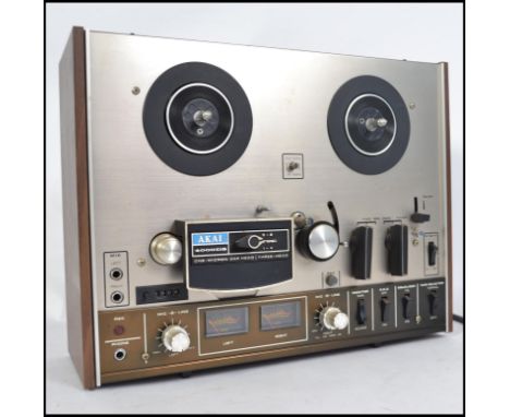 An original vintage Akai 4000DS model reel to reel tape recorder player set within original wooden surround with decorative f