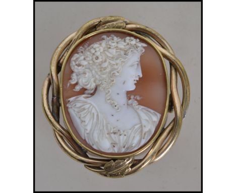 A late 19th century yellow metal mounted cameo brooch of Flora, mounted in a pinch-beck surround. 