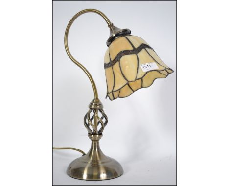 A contemporary Brass and coloured leaded glass Tiffany style desk lamp with pendant shade on arched support with terraced bas