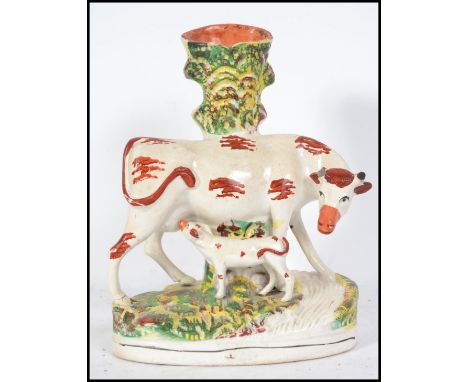 A Victorian Staffordshire ceramic spill vase flat back. The figurine diorama depicting a cow and calf on plinth base. Measure