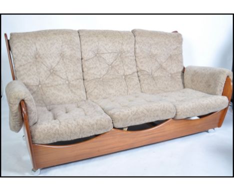 A Kofod Larsen for G-Plan vintage 20th century retro teak framed three seat ' saddle ' sofa having good shape teak wood frame