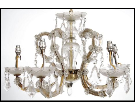 A vintage 20th century brass and glass five branch electric ceiling chandelier light fixture having glass droplets.