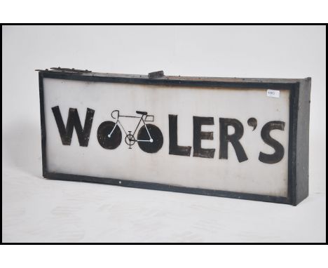 A 1970's metal and frosted acryllic ' Woolers ' double sided shop advertising industrial sign with hooks atop being set in pa