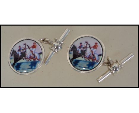 A pair of gentleman's silver and enamel set cuff links depicting horse and jockey - horse racing interest. weight 10.3g