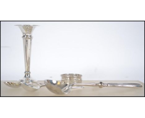 A collection of silver hallmarked items to include a candle stick, Birmingham 1973 by AT Cannon, Napkin Ring Birmingham 1929 