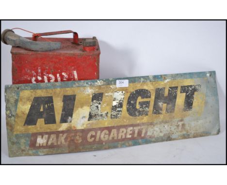 A vintage mid 20th century A1 Light Makes Cigarettes point of sale advertising sign together with a vintage painted red petro