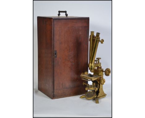 A  late 19th Victorian / early 20th Century mahogany cased gilt brass binocular microscope by  Negretti and Zambra. Complete 