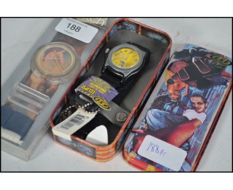 An original Pop Swatch wristwatch being complete in the original packaging and fabric strap together with a cased Fossil ' Ec
